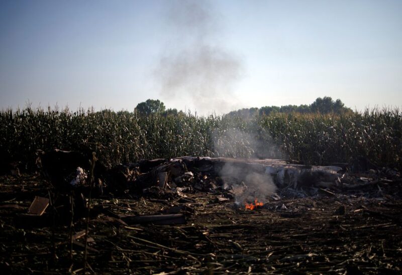 Debris burns at the crash site of an Antonov An-12 cargo plane owned by a Ukrainian company, near Kavala, Greece