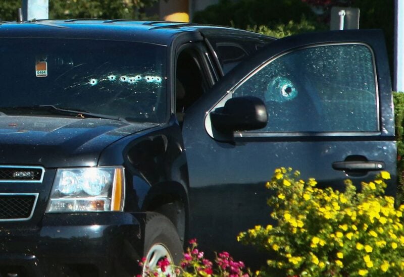 A vehicle with bullet holes visible on the windshield