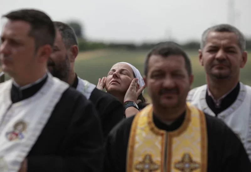 A woman prays during a religious service performed for rain to end the drought, near Draganesti-Vlasca, Teleorman county, Romania