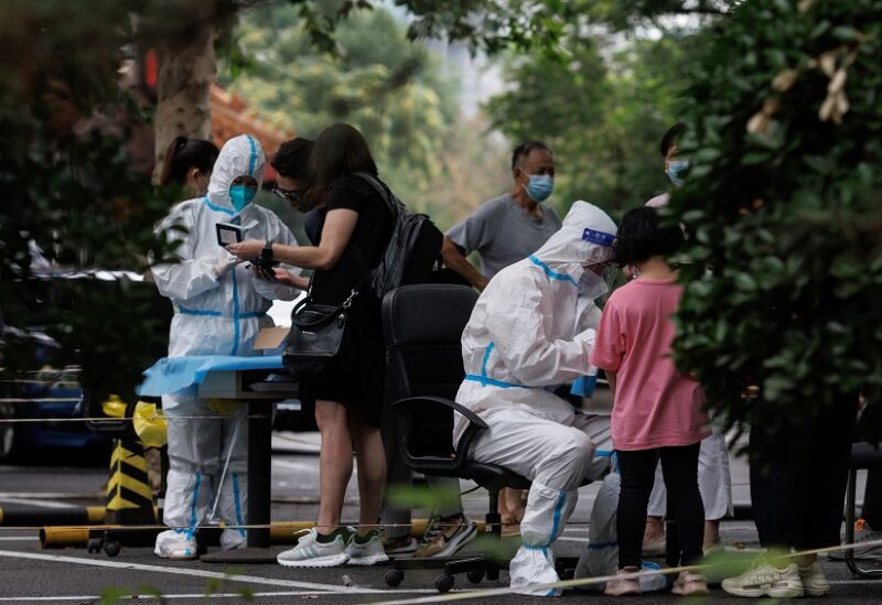 Medical workers register people at a nucleic acid testing station, following a coronavirus disease (COVID-19) outbreak, in Beijing, China, July 6, 2022. REUTERS/Thomas Peter