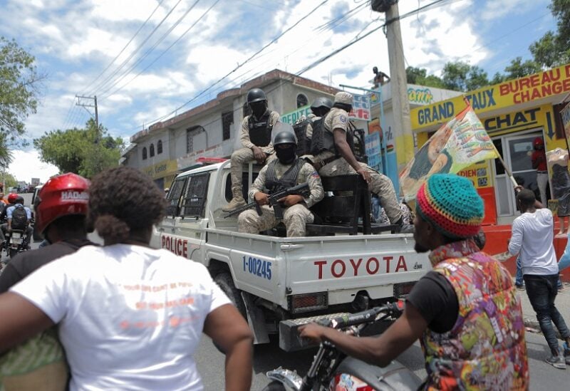 Police escort supporters of Haiti's former President Jean-Bertrand Aristide on their way to his home to congratulate him at his 69th birthday, in Port-au-Prince, Haiti July 15, 2022. REUTERS/Ralph Tedy Erol