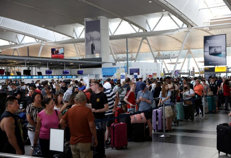 Passengers wait to check in at John F. Kennedy International Airport on the July 4th holiday weekend in Queens, New York City, U.S., July 2, 2022. REUTERS/Andrew Kelly TPX IMAGES OF THE DAY