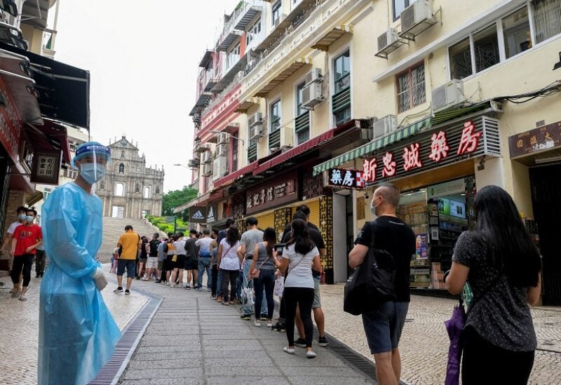 FILE PHOTO: People queue for the mass coronavirus disease (COVID-19) testing near the Ruins of Saint Paul's in Macau, China June 20, 2022. REUTERS/John Mak NO RESALES. NO ARCHIVES/File Photo