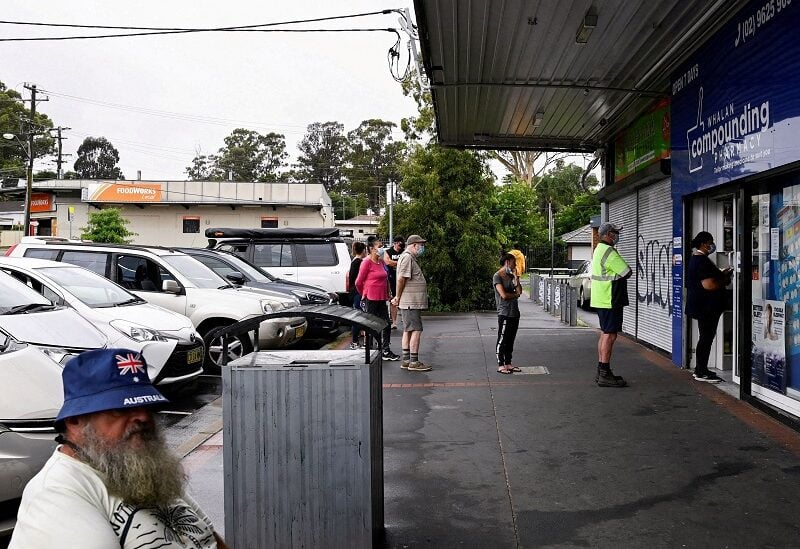 FILE PHOTO: Customers queue outside a Western Sydney chemist to purchase Rapid Antigen Test kits in the wake of the coronavirus disease (COVID-19) pandemic in Sydney, Australia, January 5, 2022. REUTERS/Jaimi Joy/File Photo