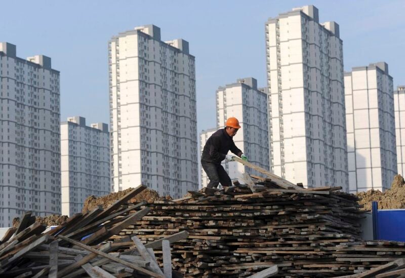 A labourer selects wooden planks as he works at a residential construction site in Hefei, Anhui province February 18, 2012. REUTERS/Stringer