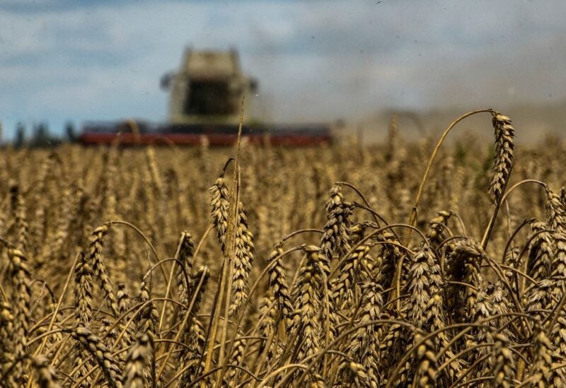 A combine harvests wheat in a field near the village of Zghurivka, amid Russia's attack on Ukraine, in Kyiv region, Ukraine August 9, 2022. REUTERS/Viacheslav Musiienko