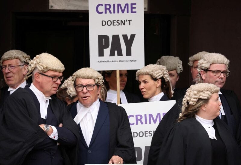 Barristers stand together during a strike by criminal barristers outside Liverpool Crown Court in Liverpool, Britain, July 4, 2022. REUTERS/Phil Noble