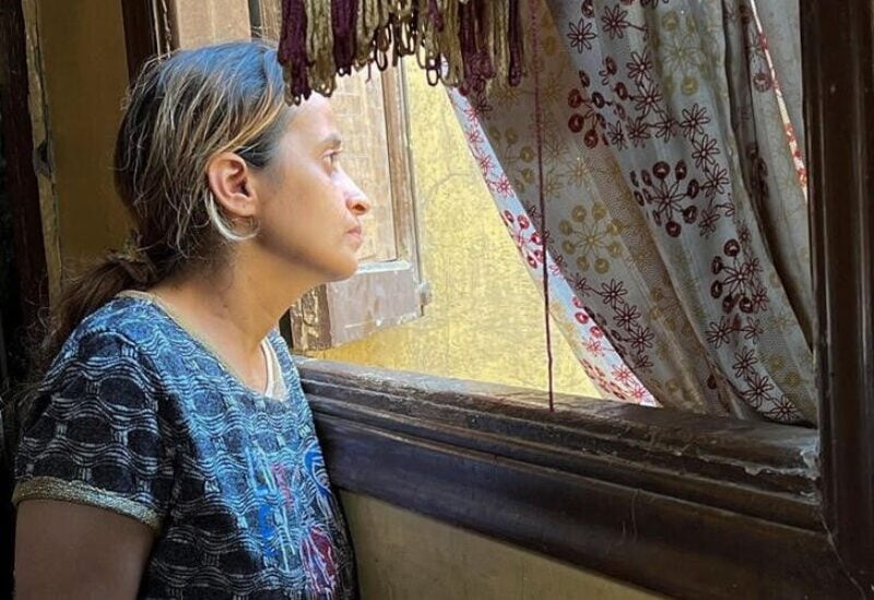 Mary Magdy, a Coptic Christian woman, looks out of a window, after an interview with Reuters TV, at her home in Cairo, Egypt July 7, 2022. A wave of high-profile domestic violence cases in Egypt has cast light on what critics describe as failures by authorities and the legal system in protecting at-risk women. REUTERS/Ahmed Fahmy