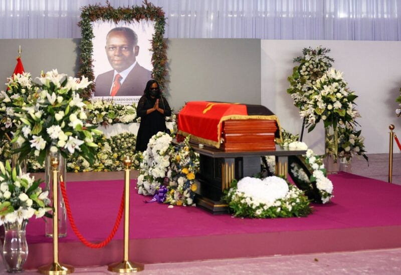 A woman pays her respect during a memorial service of Angola's former President Jose Eduardo dos Santos. REUTERS/Siphiwe Sibeko