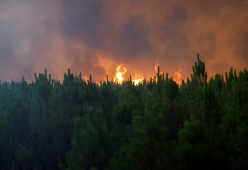 General view of smoke and flames from the fire in Belin-Beliet, as wildfires continue to spread in the Gironde region of southwestern France, August 10, 2022. REUTERS/Stephane Mahe