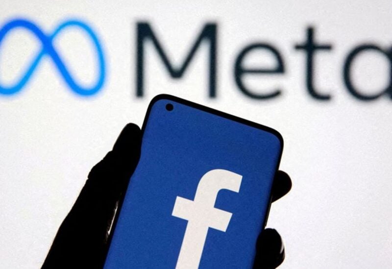 A smartphone with Facebook’s logo is seen with new rebrand logo Meta in this illustration taken October 28, 2021. REUTERS/Dado Ruvic/Illustration