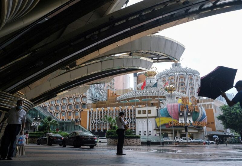 People stand near Casino Lisboa, amid the coronavirus disease (COVID-19) outbreak, in Macau, China July 4, 2022. REUTERS/John Mak