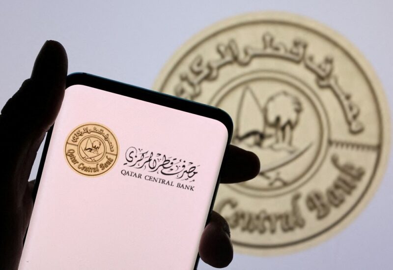 Qatar Central Bank logo is seen on a smartphone in front of displayed same logo in this illustration taken, December 1, 2021. REUTERS/Dado Ruvic/Illustration/File Photo