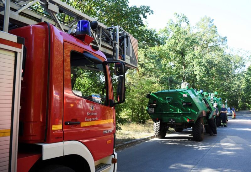 Firefighter vehicles are seen near the closed motorway access Huettenweg, due to an explosion in munitions depot in the Grunewald forest in Berlin, Germany