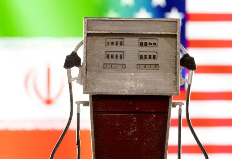 Model of petrol pump is seen in front of U.S. and Iran flag colors in this illustration taken March 25, 2022