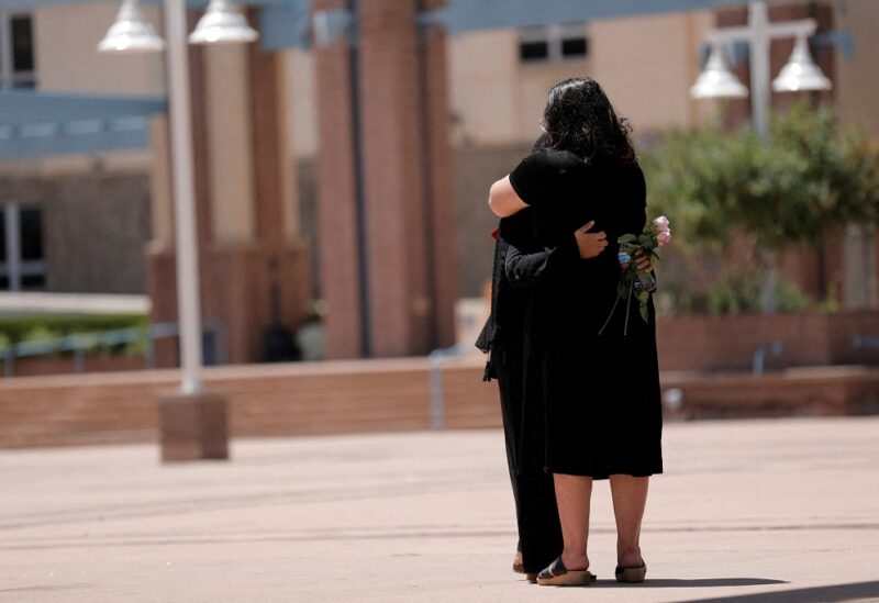 Two people embrace during a unity event against anti-Shia hate following the murders of four Muslim men in Albuquerque, New Mexico, U.S., August 12, 2022. REUTERS/Adria Malcolm/File Photo
