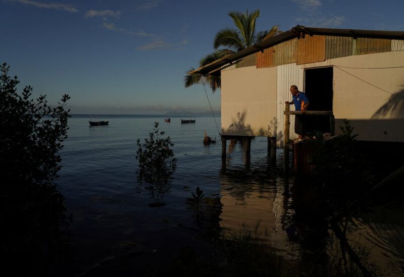 Local resident Rapuma Tuqio, 67, looks out at seawater flooding around his home at high tide in Veivatuloa Village, Fiji, July 16, 2022. He has lived in the village for around 20 years, including 12 or 13 years in that seaside home. REUTERS/Loren Elliott