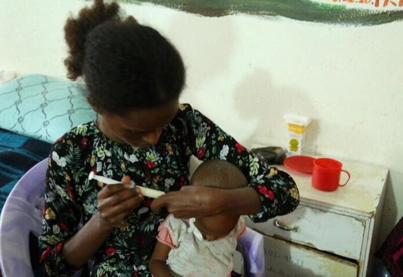 Brkti Gebrehiwot, a 20-year-old woman from Agulae, a town previously occupied by Eritrean troops, tries to feed her one year and eight month old son Aamanuel Merhawi, who suffers from severe acute malnutrition at Wukro hospital in Wukro, Tigray region, Ethiopia, July 11, 2021. REUTERS/Giulia Paravicini/File Photo