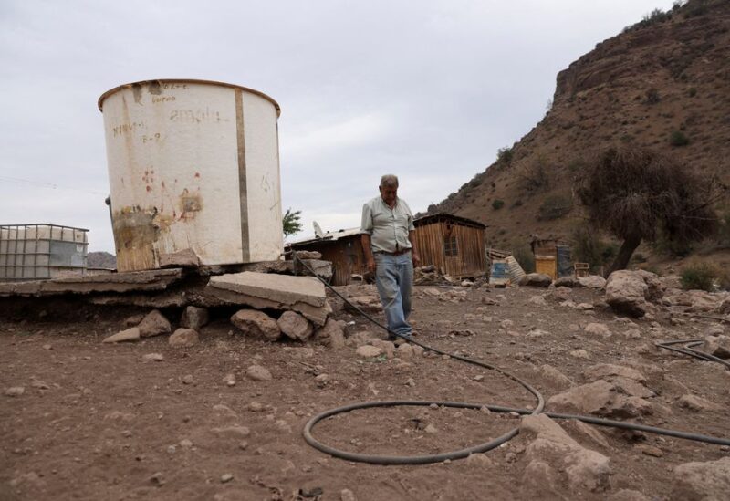 Segundo Aballay, 75, a rancher, walks next to a water container used for his animals at Montenegro in Santiago, Chile April 21, 2022. "If it doesn't rain this year we will be left with nothing to do," Aballay said. "The animals are getting weaker and dying day by day." REUTERS/Ivan Alvarado