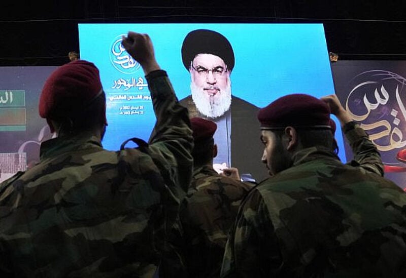 File: Hezbollah fighters raise their hands as their leader Hassan Nasrallah speaks via a video link during a rally to mark Jerusalem day or Al-Quds day, in a southern suburb of Beirut, Lebanon, April 29, 2022. (AP Photo/Hassan Ammar)