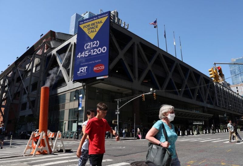 People walk by the Port Authority Bus Terminal where earlier migrants arrived from Texas under the order of Texas Governor Greg Abbott in Manhattan, New York City, U.S