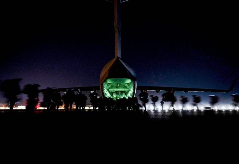 U.S. Soldiers, assigned to the 82nd Airborne Division, prepare to board a U.S. Air Force C-17 Globemaster III aircraft to leave Hamid Karzai International Airport in Kabul, Afghanistan