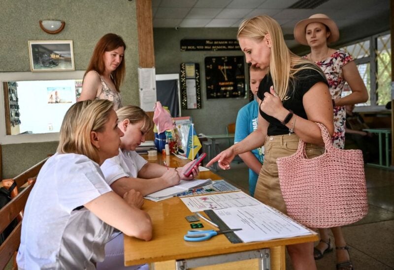 Zaporizhzhia residents queue at the local administration office to receive iodine tablets in the city's eastern Khortytskyi district as fears of a nuclear accident at Europe's largest nuclear power plant