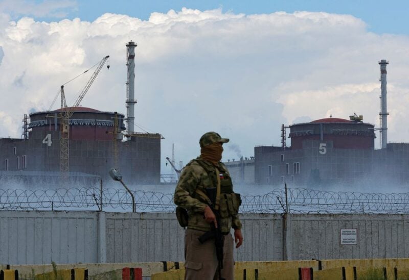 A serviceman with a Russian flag on his uniform stands guard near the Zaporizhzhia Nuclear Power Plant in the course of Ukraine-Russia conflict