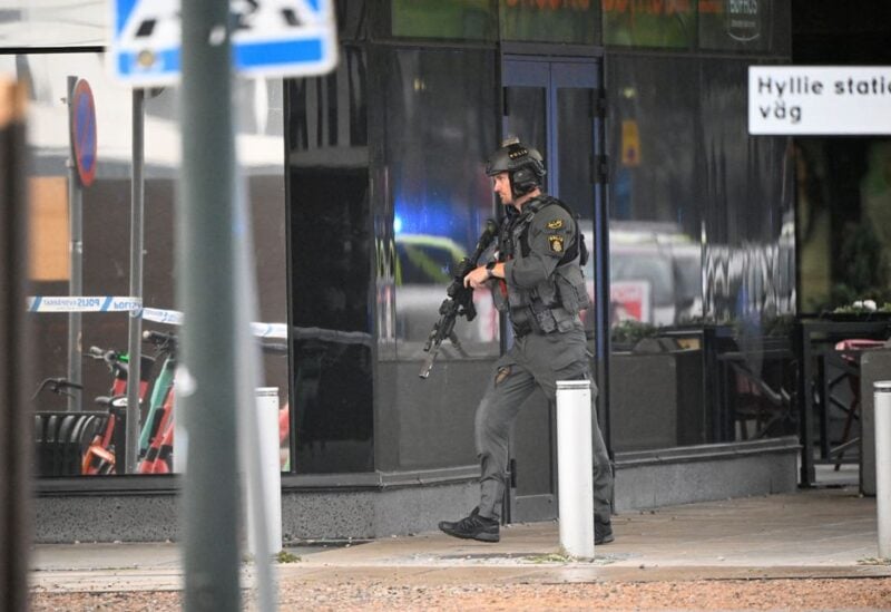 A member of the police works at the scene of a shooting at Emporia Shopping Center in Malmo, Sweden, August 19, 2022