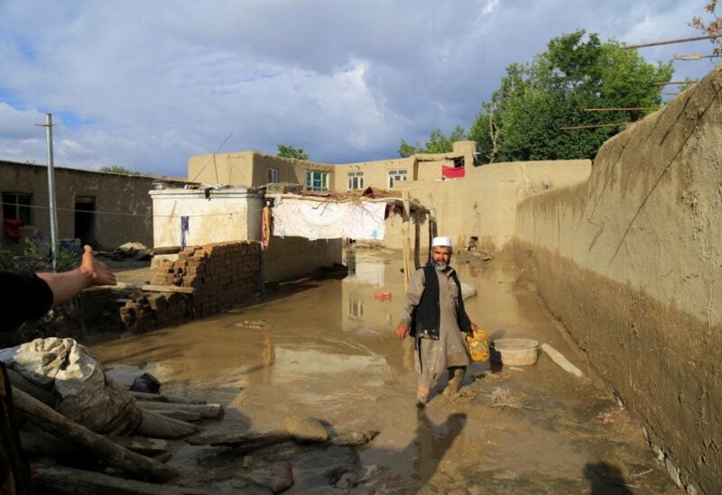 An Afghan man cleans up his damaged home after the heavy flood in the Khushi district of Logar, Afghanistan, August 21, 2022. REUTERS