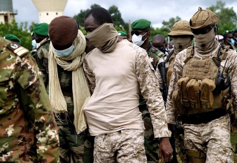 FILE PHOTO: Colonel Assimi Goita, the junta leader of the National Committee for the Salvation of the People (CNSP) which overthrew Mali's President Ibrahim Boubacar Keita attends an honour ceremony for the ten Malian soldiers that the army said were killed in militant attacks in Gueri town, at the army headquarters in Kati, Mali September 6, 2020. REUTERS/Matthieu Rosier/File Photo