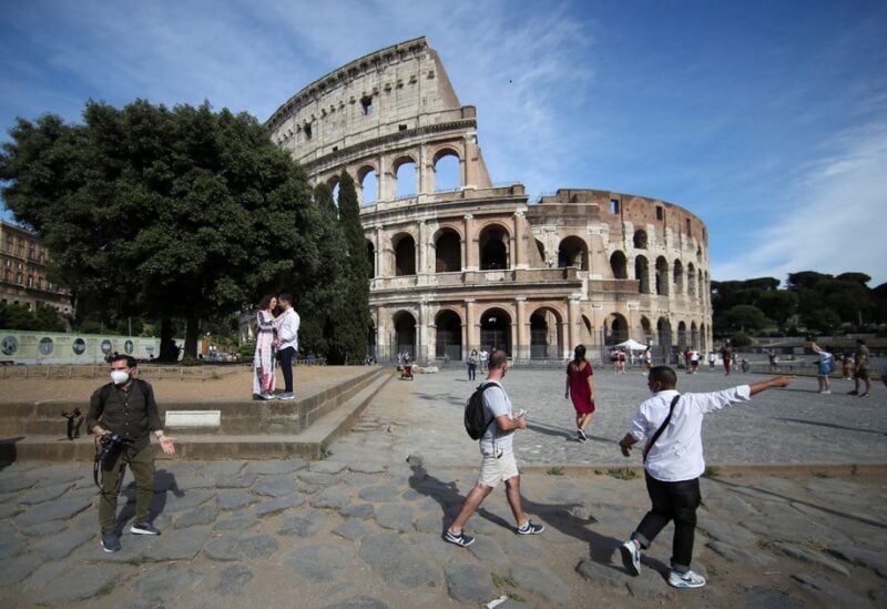 People walk outside the Colosseum, in Rome, Italy, June 4, 2021. REUTERS/Yara Nardi