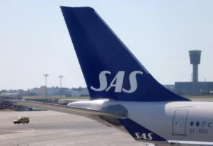 The tail fin of a parked Scandinavian Airlines (SAS) airplane is seen on the tarmac at Copenhagen Airport Kastrup in Copenhagen, Denmark, July 3, 2022