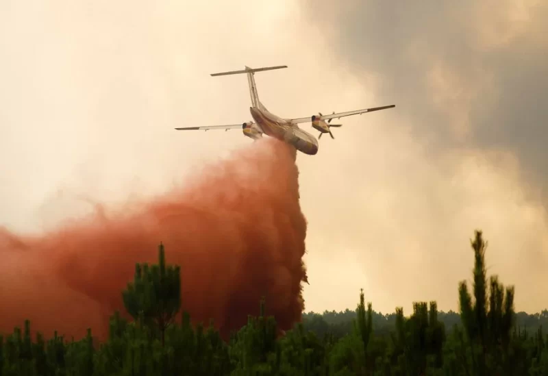 A firefighting plane drops flame retardant to extinguish a fire in Belin-Beliet, as wildfires continue to spread in the Gironde region of southwestern France, August 10, 2022