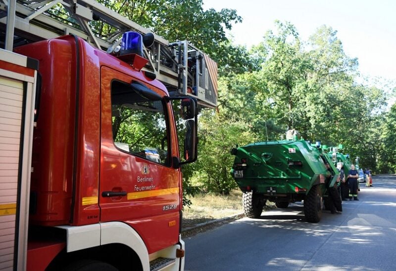 Firefighter vehicles are seen near the closed motorway access Huettenweg, due to an explosion in munitions depot in the Grunewald forest in Berlin, Germany August 4, 2022. REUTERS/Annegret Hilse