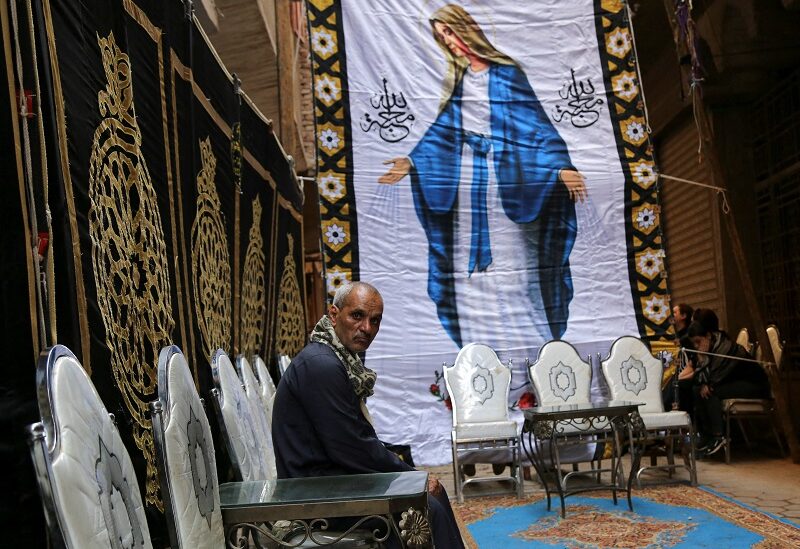 A man looks on as people come to pay condolences for Adel Agieb and Nadia Saied, who lost their lives in the Abu Sifin church fire during Sunday Mass, outside their house, in the Imbaba district of Giza, Egypt August 15, 2022. REUTERS/Hanaa Habib