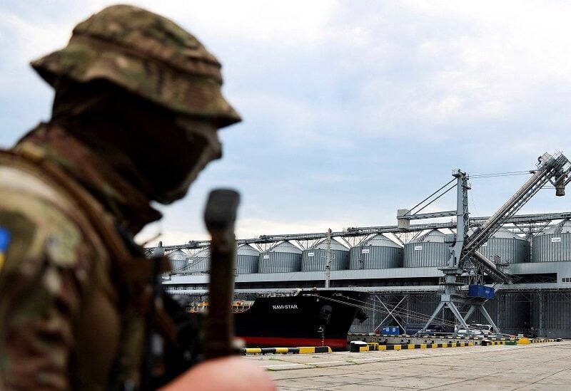 FILE PHOTO: A Ukrainian serviceman stands in front of silos of grain from Odesa Black Sea port, before the shipment of grain as the government of Ukraine awaits signal from UN and Turkey to start grain shipments, amid Russia's invasion of Ukraine, in Odesa, Ukraine July 29, 2022. REUTERS/Nacho Doce/File Photo