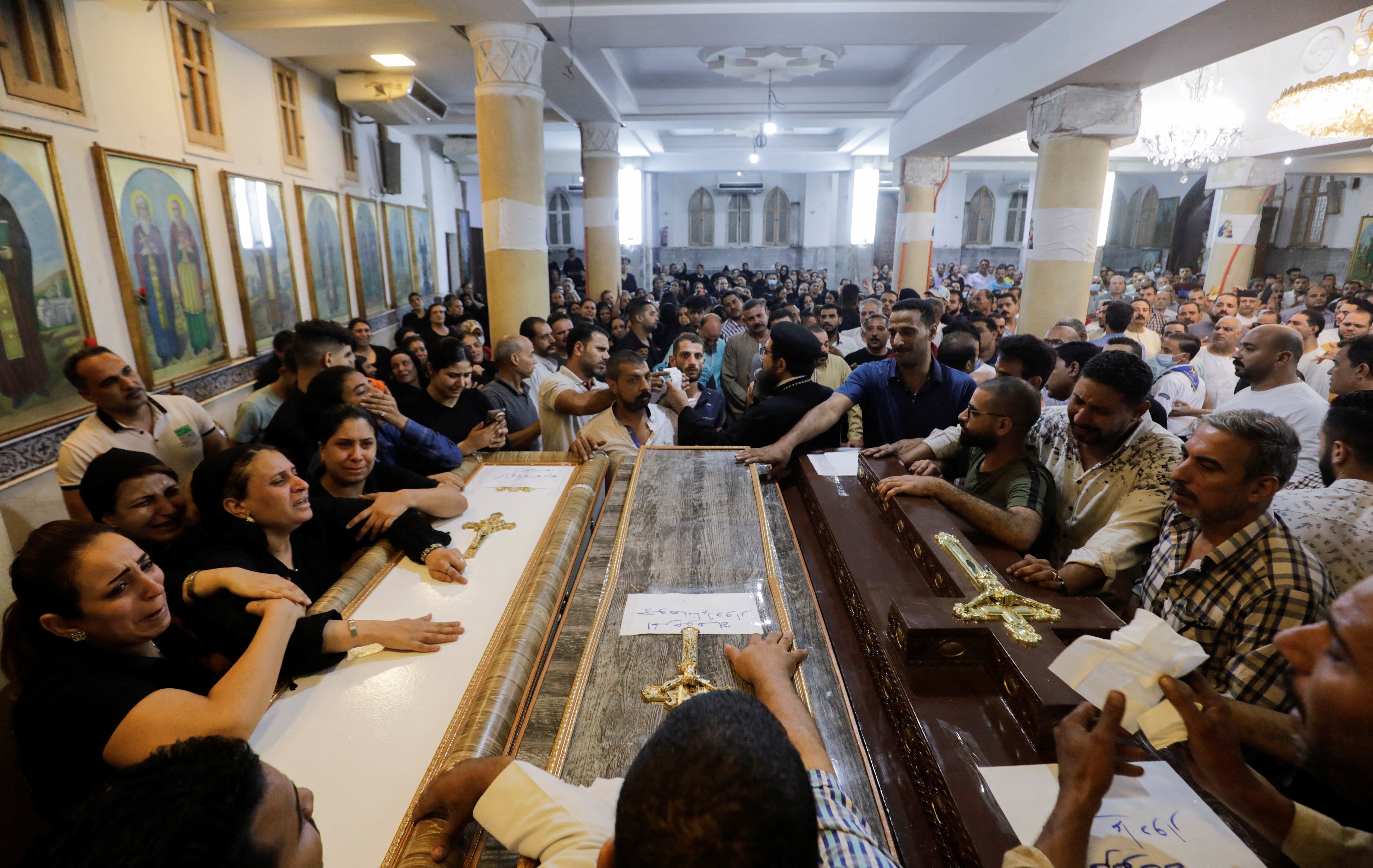 People react during the funeral of victims, who died due to the fire that broke out at the Abu Sifin church, inside the Church of the Blessed Virgin Mary at Warraq Al Arab district in Giza Governorate, Egypt, August 14, 2022. REUTERS/Mohamed Abd El Ghany