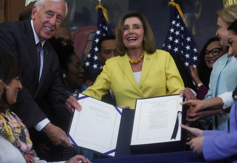 House Majority Leader Steny Hoyer (D-MD), Speaker of the House Nancy Pelosi and Rep. Carolyn Maloney (D-NY) hold a signed copy of H.R. 6376, the "Inflation Reduction Act of 2022," at an enrollment ceremony after the bill passed the House at the U.S. Capitol on Capitol Hill in Washington, August 12, 2022. REUTERS/Leah Millis