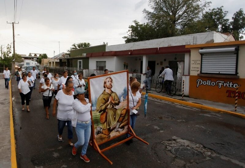 People take part in a procession for the miners trapped in a coal mine that collapsed in Sabinas, Coahuila state, in San Jose de Cloete, Mexico August 12, 2022. REUTERS/Daniel Becerril