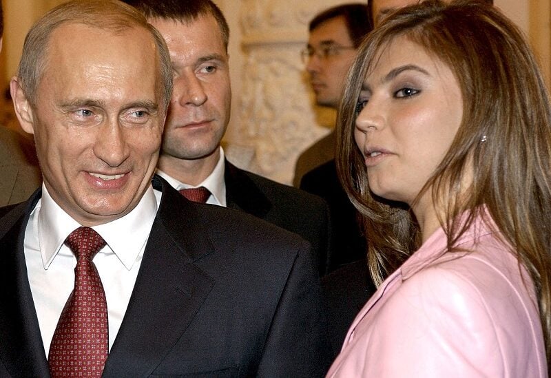 FILE PHOTO: Russian President Vladimir Putin (L) smiles next to Russian gymnast Alina Kabaeva during a meeting with the Russian Olympic team at the Kremlin in Moscow, Russia in this November 4, 2004 file photo. REUTERS/ITAR-TASS/PRESIDENTIAL PRESS SERVICE/File Photo