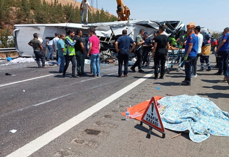 Rescue and emergency responders work at the scene after a bus crash on the highway between Gaziantep and Nizip, Turkey August 20, 2022. Ihlas News Agency via REUTERS ATTENTION EDITORS - THIS IMAGE WAS PROVIDED BY A THIRD PARTY. TURKEY OUT. NO COMMERCIAL OR EDITORIAL SALES IN TURKEY. NO RESALES. NO ARCHIVES