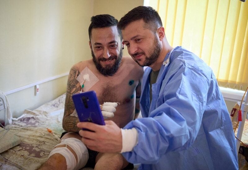 Ukraine's President Volodymyr Zelenskiy makes a selfie with an injured Ukrainian serviceman in a hospital, as Russia's attack on Ukraine continues, in Odesa, Ukraine July 29, 2022. Ukrainian Presidential Press Service/Handout via REUTERS ATTENTION EDITORS - THIS IMAGE HAS BEEN SUPPLIED BY A THIRD PARTY. TPX IMAGES OF THE DAY