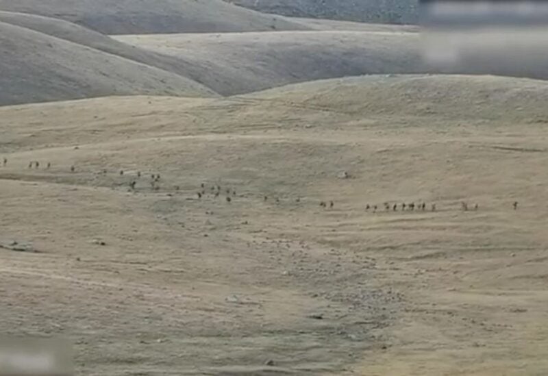 A still image from video, released by the Armenian Defence Ministry, shows what it said to be Azerbaijani service members moving along an unidentified mountainous border area with Armenia, in this still image taken from handout footage released September 13, 2022. Armenian Defence Ministry/Handout via REUTERS