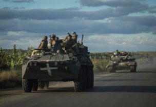 Ukrainian servicemen ride on Armoured Personnel Carrier (APC) and a tank, as Russia's attack on Ukraine continues, near the town of Izium, recently liberated by Ukrainian Armed Forces, in Kharkiv region, Ukraine September 19, 2022. REUTERS/Gleb Garanich
