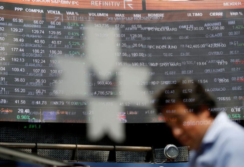 An employee is pictured behind the logo of the Mexican stock exchange at the stock exchange in Mexico City, Mexico, March 2, 2020. REUTERS/Gustavo Graf