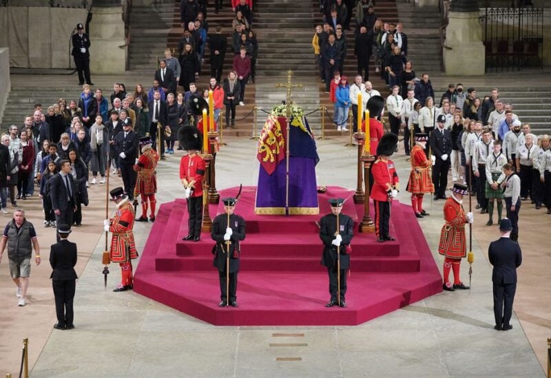 At 5.17am on the day of her funeral the final members of the public pay their respects at the coffin of Queen Elizabeth II, draped in the Royal Standard with the Imperial State Crown and the Sovereign's orb and sceptre, lying in state on the catafalque in Westminster Hall, at the Palace of Westminster, London. Picture date: Monday September 19, 2022. Yui Mok/Pool via REUTERS