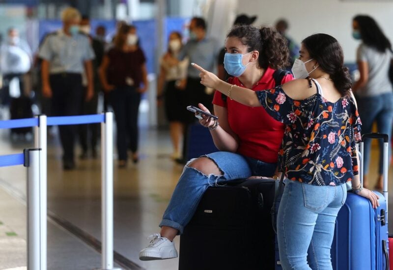 Passengers wear protective masks after the outbreak of the coronavirus disease (COVID-19) at the airport in Frankfurt, Germany, August 11, 2020. REUTERS/Kai Pfaffenbach