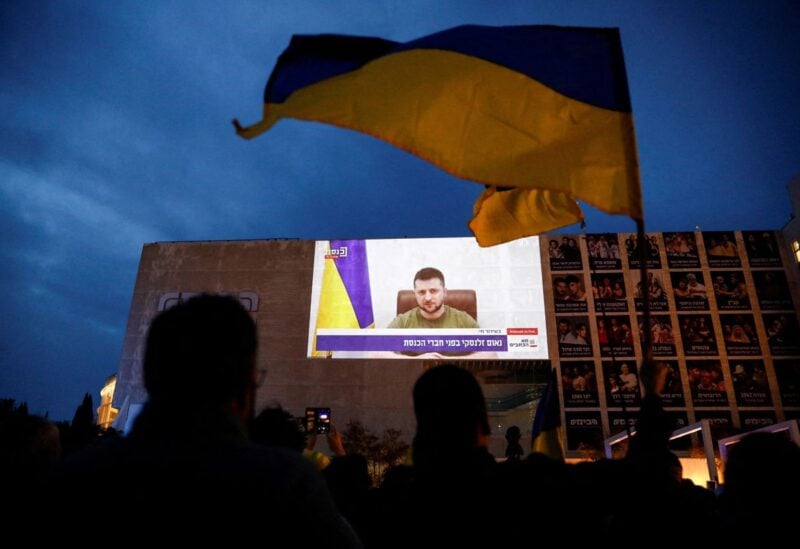 Demonstrators gather in support of Ukraine following Russia's invasion, and watch Zelenskiy's speech as it is broadcasted to the Knesset, Israel's parliament, and projected at Habima Square in Tel Aviv, Israel, March 20, 2022. REUTERS/Corinna Kern/File Photo