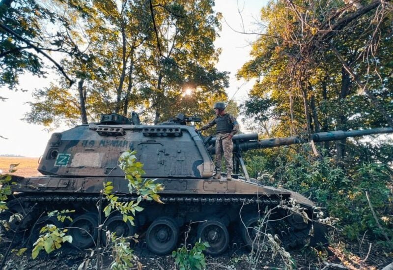A Ukrainian service member stands on a Russian 2S19 Msta-S self-propelled howitzer captured during a counteroffensive operation, amid Russia's attack on Ukraine, in Kharkiv region, Ukraine, in this handout picture released September 12, 2022. Press service of the 25th Airborne Brigade of the Armed Forces of Ukraine/Handout via REUTERS